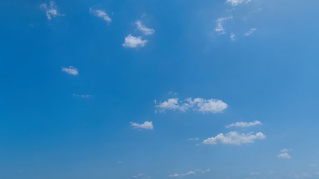 White Fluffy Clouds Floating in the Bright Blue Skies on a Summer Day