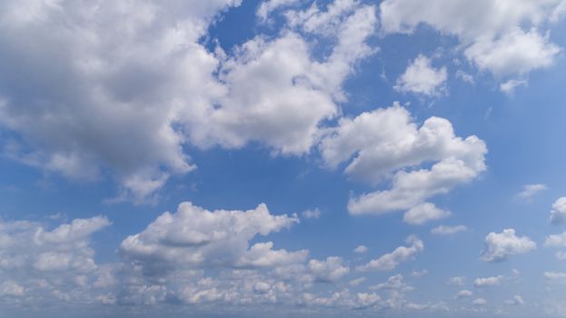 White and Dark Fluffy Clouds Floating in the Bright Blue Skies on a Summer Day