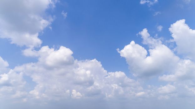 White Fluffy Clouds Floating in the Bright Blue Skies on a Summer Day