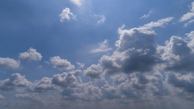 White and Dark Fluffy Clouds Floating in the Bright Blue Skies on a Summer Day