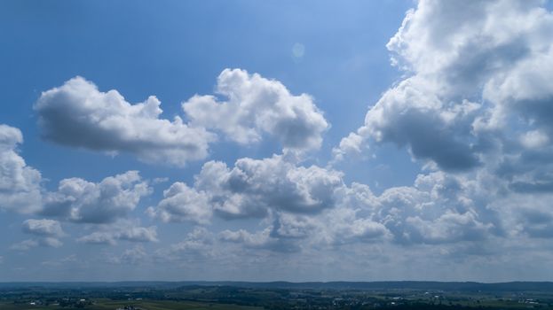 White and Dark Fluffy Clouds Floating in the Bright Blue Skies on a Summer Day