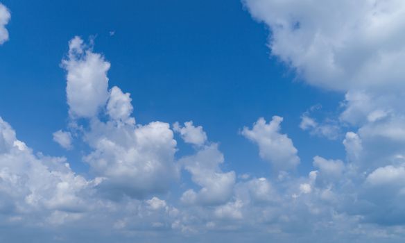 White Fluffy Clouds Floating in the Bright Blue Skies on a Summer Day