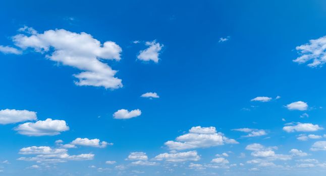White Fluffy Clouds Floating in the Bright Blue Skies on a Summer Day