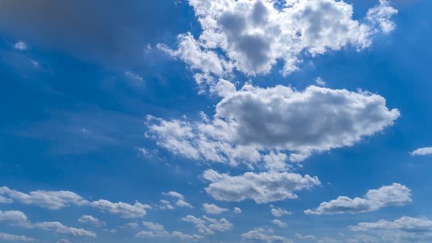 White and Dark Fluffy Clouds Floating in the Bright Blue Skies on a Summer Day