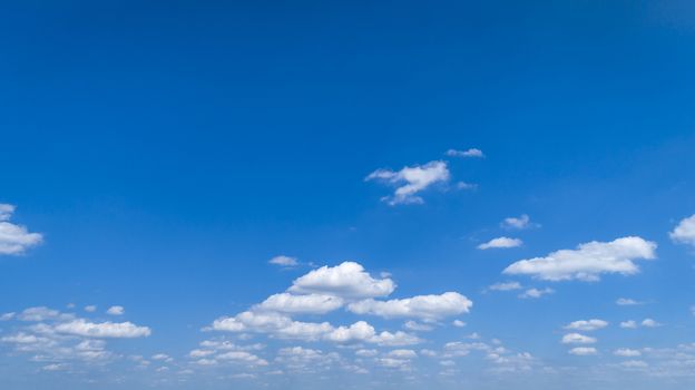 White Fluffy Clouds Floating in the Bright Blue Skies on a Summer Day