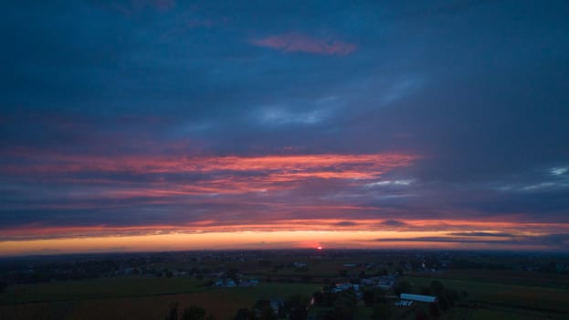 An Aerial View of a Sunset with Red and Blues on a Summer Night