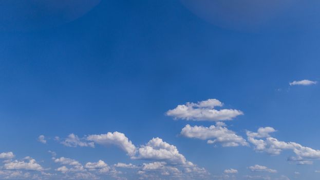 White Fluffy Clouds Floating in the Bright Blue Skies on a Summer Day