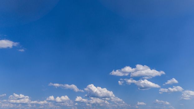 White Fluffy Clouds Floating in the Bright Blue Skies on a Summer Day