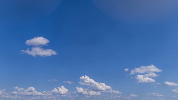 White Fluffy Clouds Floating in the Bright Blue Skies on a Summer Day