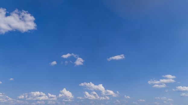 White Fluffy Clouds Floating in the Bright Blue Skies on a Summer Day