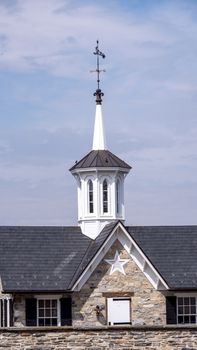 View of a Steeple Cupolas with a Weather Vane on a Sunny Summer Day