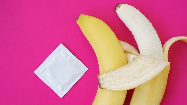 Condoms and two bananas, concept of contraceptives and the prevention of venereal diseases of same-sex marriage. The concept of a friendly couple.