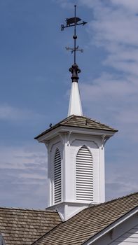 View of a Steeple Cupolas with a Weather Vane on a Sunny Summer Day