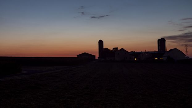 An Aerial View of a Sunrise Over an Amish Farm with Blues and Reds on a Clear Summer Morning