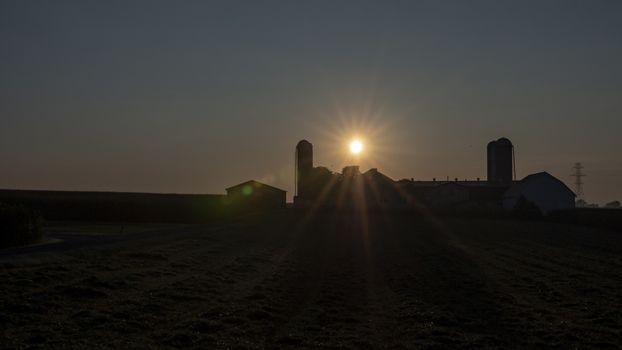 An Aerial View of a Sunrise Over an Amish Farm with Blues and Reds on a Clear Summer Morning