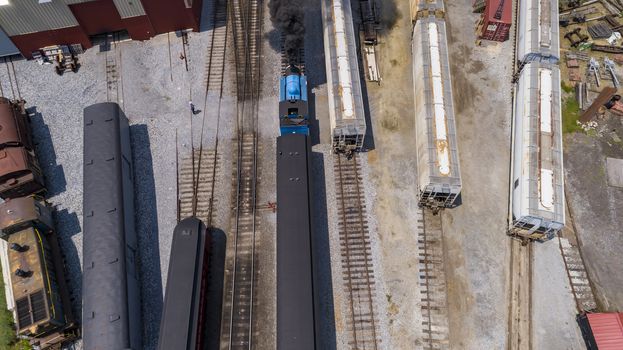 Aerial View of Train Yard Waiting for Thomas the Train Puffing Smoke on a Sunny Summer Day