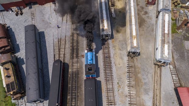 Aerial View of Train Yard Waiting for Thomas the Train Puffing Smoke on a Sunny Summer Day