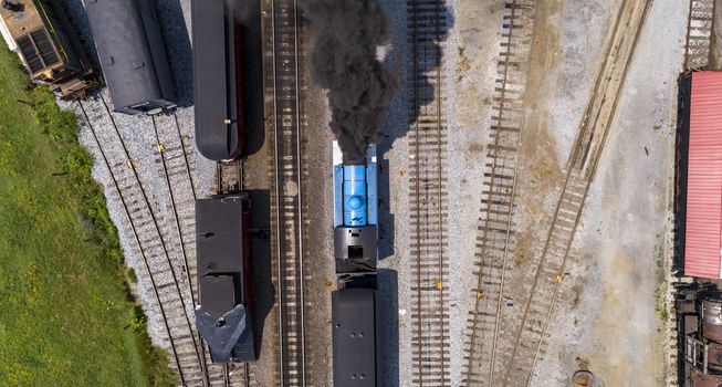 Aerial View of Train Yard Waiting for Thomas the Train Puffing Smoke on a Sunny Summer Day