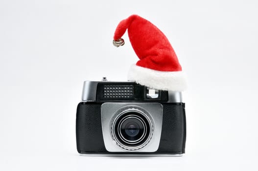 Vintage camera surrounded by Christmas toys, Santa's Christmas tree and caps.For Isolation.
