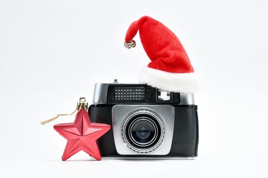 Vintage camera surrounded by Christmas toys, Santa's Christmas tree and caps.For Isolation.
