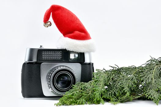 Vintage camera surrounded by Christmas toys, Santa's Christmas tree and caps.For Isolation.