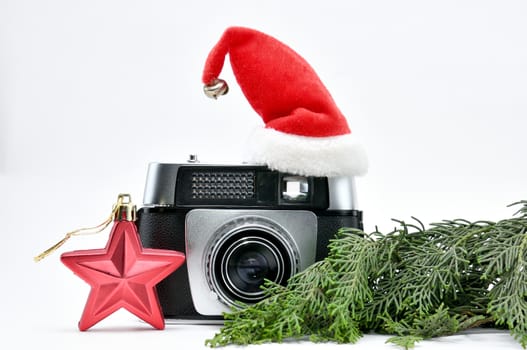 Vintage camera surrounded by Christmas toys, Santa's Christmas tree and caps.For Isolation.