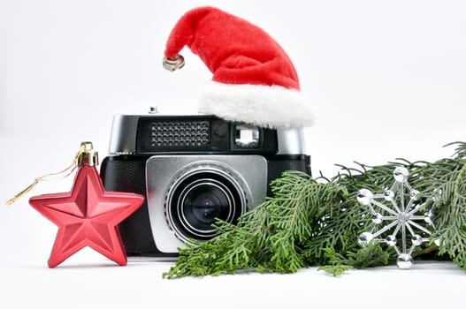 Vintage camera surrounded by Christmas toys, Santa's Christmas tree and caps.For Isolation.