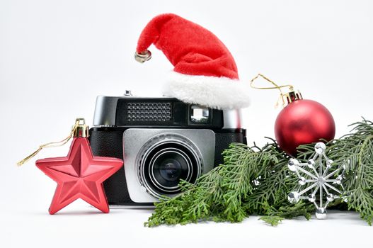 Vintage camera surrounded by Christmas toys, Santa's Christmas tree and caps.For Isolation.
