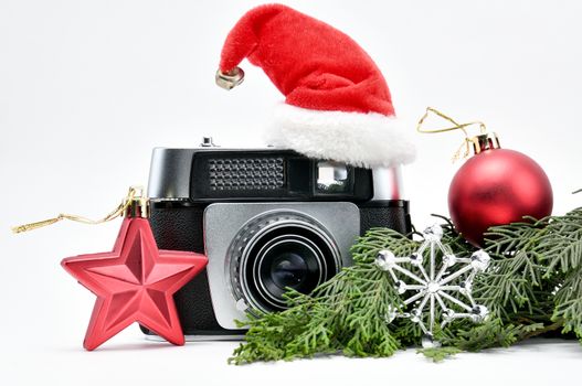 Vintage camera surrounded by Christmas toys, Santa's Christmas tree and caps.For Isolation.
