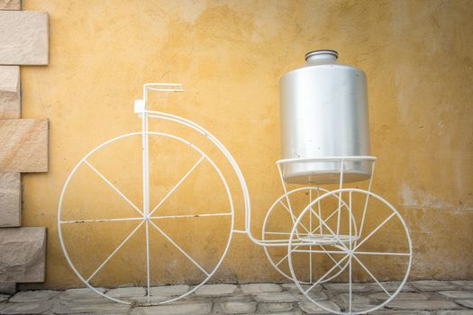light on white decor bicycle on the rock wall background.