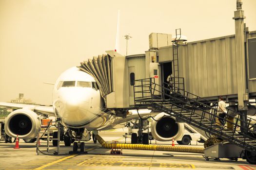 Airplane near the terminal in an airport cockpit shoot on the bus,vintage color style