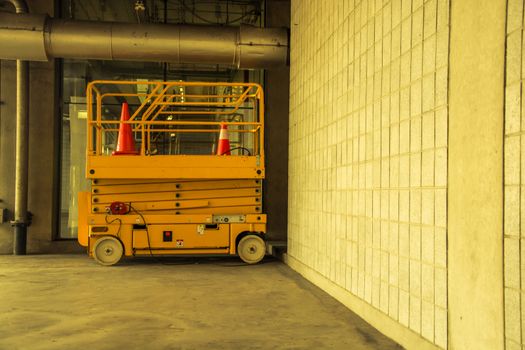 distribution warehouse hall with hydraulic scissors lift platform, vintage color style