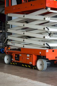 distribution warehouse hall with hydraulic scissors lift platform