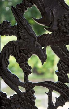 Carved wooden door detail of bird