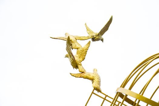 gold Sculpture of a Dove Being Set Free