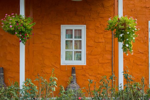 Window With Flower Basket On Orange Wall
