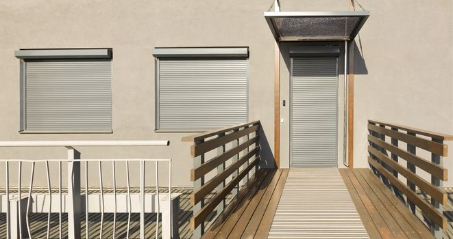 Light beige metal blinds on the doors and windows of the house