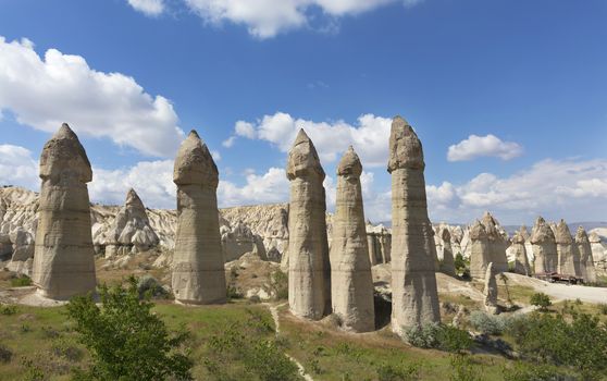 Rural landscape in the Valley of Love, Cappadocia. Large phallic rock formations against the blue summer sky.