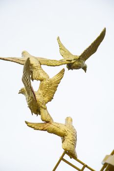 gold Sculpture of a Dove Being Set Free