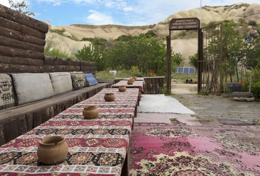 The hospitable view of the old cafe of a high-rise Turkish courtyard in Cappadocia