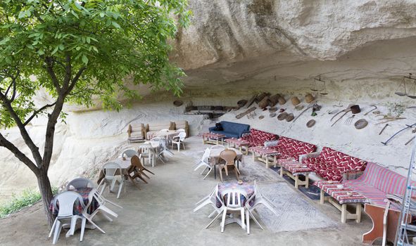 A welcoming view of an old cafe in a high-rise Turkish courtyard in Cappadocia