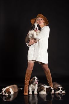 Young woman and little puppies ona studio background
