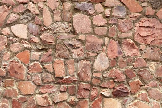 The wall is made of natural coarse red granite with embroidered borders of cement