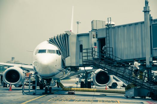 Airplane near the terminal in an airport cockpit shoot on the bus,vintage color style