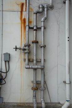 grunge iron pipeline and plumbing connection joints with industrial tap fittings, faucets and valve