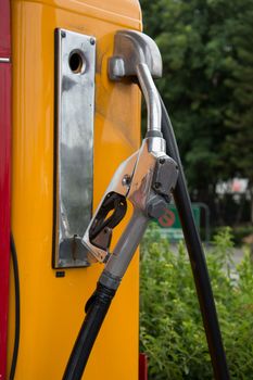 the Gas pump nozzles in the retro service station, vintage color tone