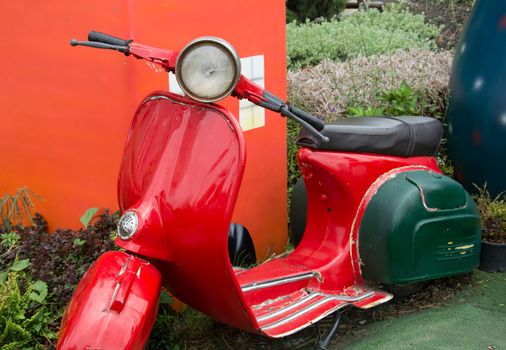 vintage scooter parked in garden,vintage tone