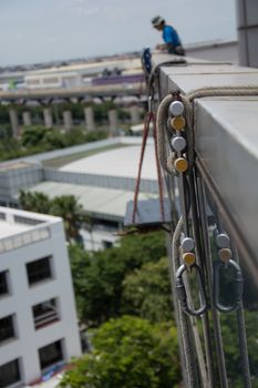 workers cleaning windows service on high rise building