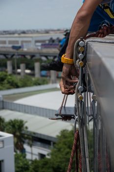 workers cleaning windows service on high rise building