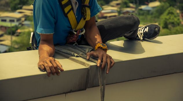 workers cleaning windows service on high rise building